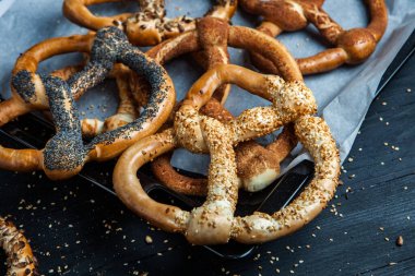 Taze ev yapımı yumuşak krakerler. Siyah arka planda tohumları olan farklı türde kraker..