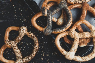 Taze ev yapımı yumuşak krakerler. Siyah arka planda tohumları olan farklı türde kraker..