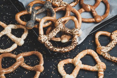 Taze ev yapımı yumuşak krakerler. Siyah arka planda tohumları olan farklı türde kraker..