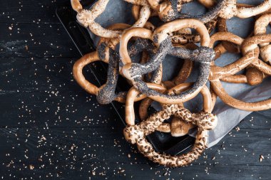 Taze ev yapımı yumuşak krakerler. Siyah arka planda tohumları olan farklı türde kraker..