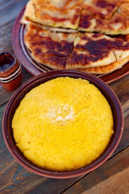 Polenta, mısır unundan yapılmış, kitap ve peynirle servis edilen bir yemektir. Romanya ve Moldova Cumhuriyeti 'nde geleneksel gıda