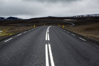 Very picturesque empty road in iceland in summer. Asphalt road as a symbol of freedom and travel.