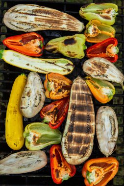 Fresh vegetables prepared on the grill outside. Tomatoes, sweet peppers, eggplant cooked outside.