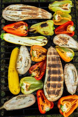 Fresh vegetables prepared on the grill outside. Tomatoes, sweet peppers, eggplant cooked outside.