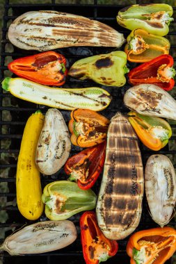 Fresh vegetables prepared on the grill outside. Tomatoes, sweet peppers, eggplant cooked outside.