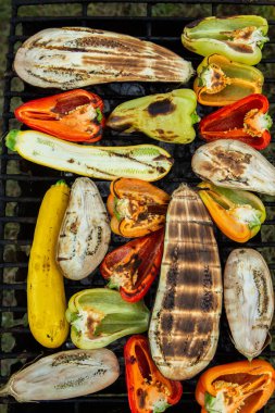Fresh vegetables prepared on the grill outside. Tomatoes, sweet peppers, eggplant cooked outside.