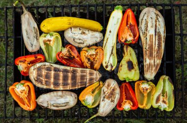 Fresh vegetables prepared on the grill outside. Tomatoes, sweet peppers, eggplant cooked outside.