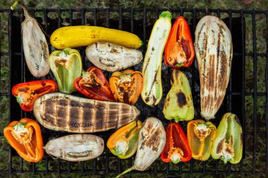 Fresh vegetables prepared on the grill outside. Tomatoes, sweet peppers, eggplant cooked outside.