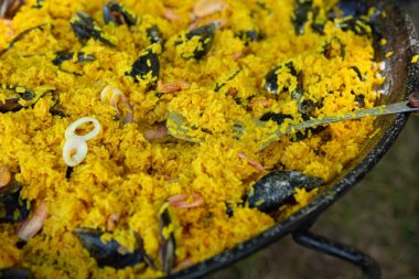 Paella traditional Spanish food. paella prepared on a large pan on the street on fire