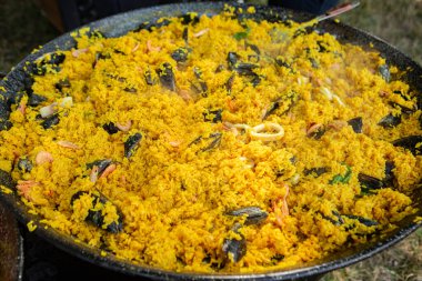 Paella traditional Spanish food. paella prepared on a large pan on the street on fire