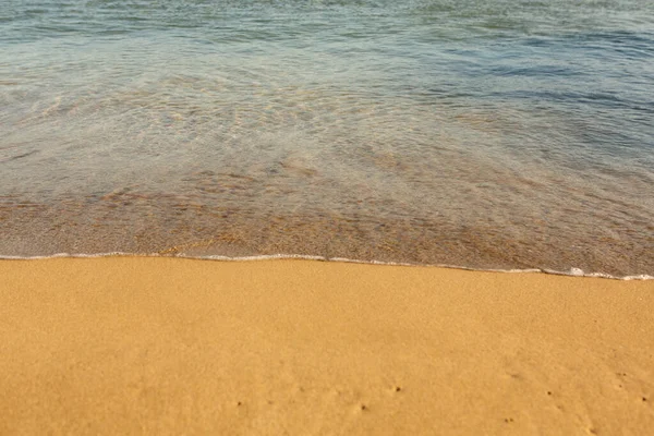 クレタ島の海岸に黄金の砂と背景 テキストのための砂と澄んだ海の水の抽象的な表面 ストック画像