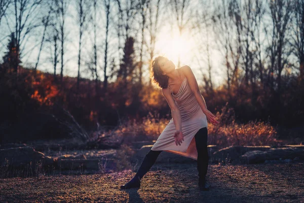 Mulher bonita dançando na natureza ao pôr do sol. — Fotografia de Stock