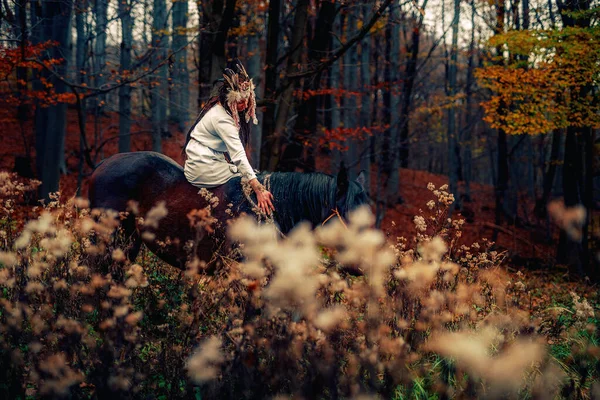 Shaman woman in autumn landscape with her horse. — Fotografia de Stock