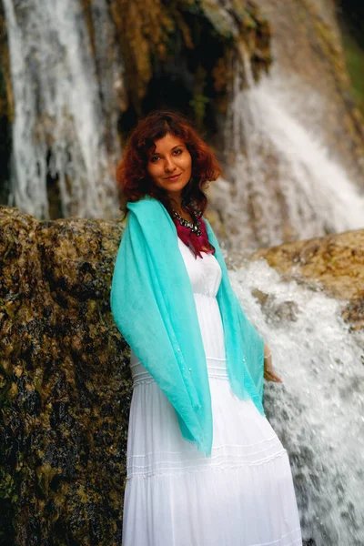 Beautiful woman in beautiful dresses near the waterfall. — Stock Photo, Image