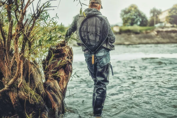 Fisherman with rod fishing on the river. — Stock Photo, Image
