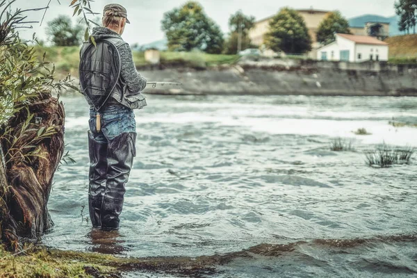 Fisherman with rod fishing on the river. — Stock Photo, Image