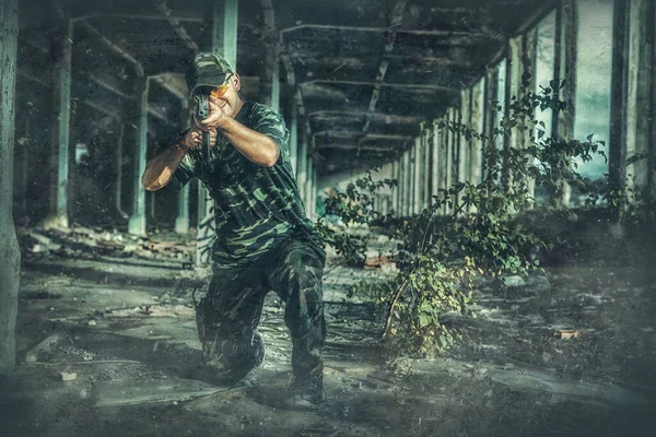 Airsoft hand in the hand industry building. Old photo effect. — Stockfoto