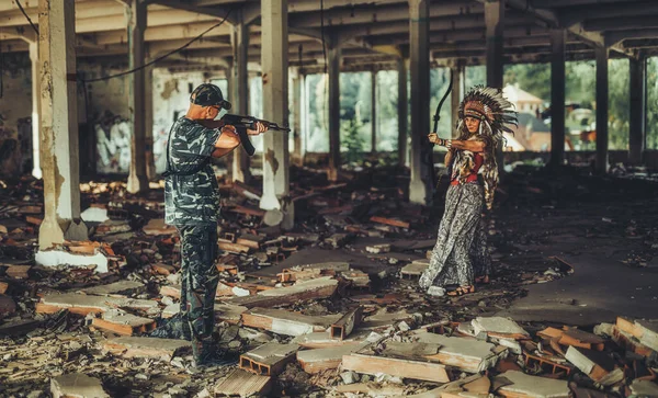 Soldat Airsoft et femme indienne dans l'ancien bâtiment de l'industrie. — Photo