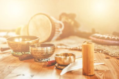 A still life of the shamanic drum and tibetan singing bowls