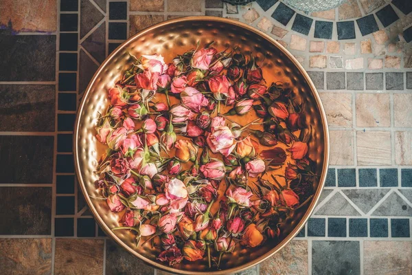 Rose flower in a brass bowl. Spa and aromatherapy