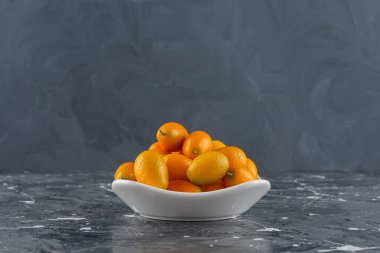 Mermer arka planda yaprakları olan taze kumkatlı meyveler. Yüksek kalite fotoğraf