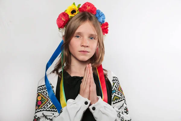 Припиніть війну в Україні. Блондинка, що молиться в традиційному українському одязі. Біле тло. — стокове фото