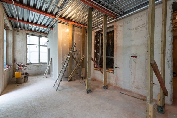 Interior of apartment during construction, remodeling, renovation, extension, restoration and reconstruction - ladder and construction materials in the room — Stock Photo, Image