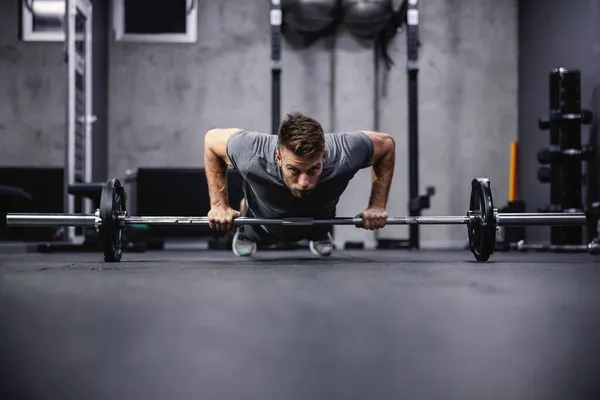근육을 강화하고 매력적 근육질인 남자가 소리에 올리는 합니다 운동복을 체육관에서 — 스톡 사진