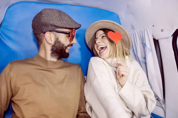 一对浪漫的夫妇在摄影棚里玩得很开心 一对笑着的年轻夫妇坐在摄影棚里玩乐 — 图库照片