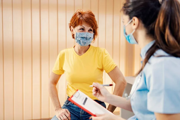 Healthcare Insurance Medical Service Woman Mask Sitting Doctor Office Talking — Stock Photo, Image