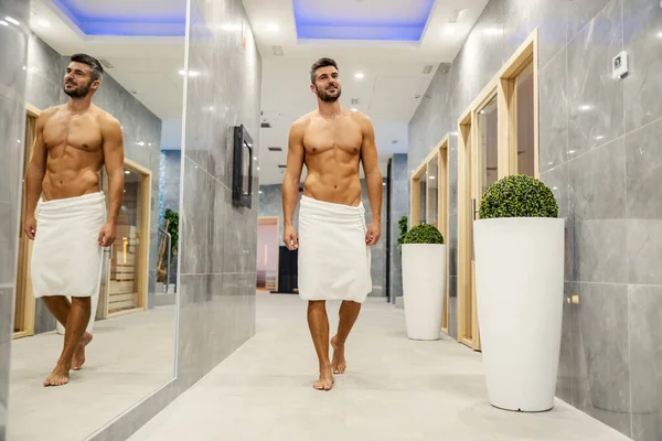 Handsome Muscular Macho Man Wrapped Towel Walking Spa Center Searching — стоковое фото
