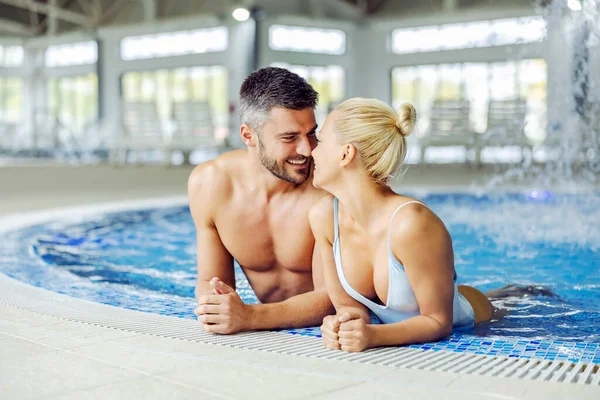 水着を愛する中年のカップルはリラックスしていて 温水でプールでいちゃついています スパセンターで覚えておくべき瞬間 温水プールのカップル — ストック写真
