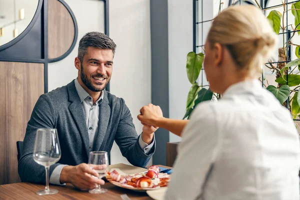 Bearded Happy Man Sitting His Woman Restaurant Holding Her Hand — Stockfoto