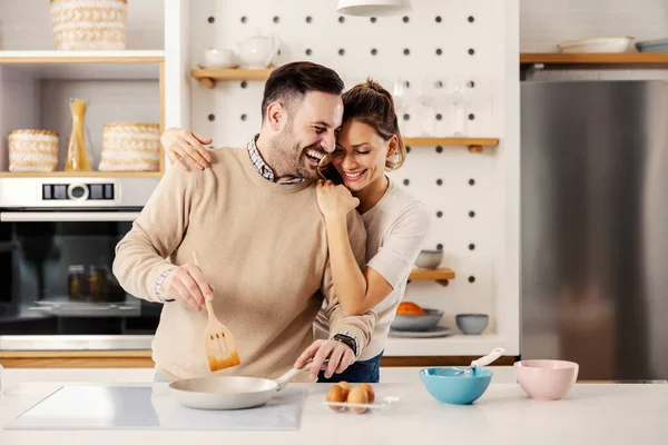 Man Kitchen Preparing Meal While His Wife Hugging Him — Stock Photo, Image