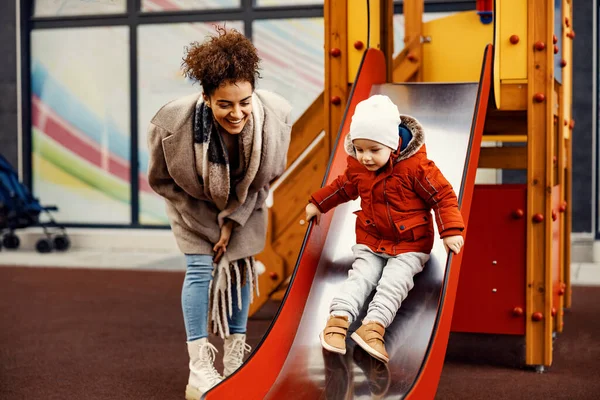 Nanny Babysitting Little Boy Playground Woman Encourages Little Boy Slides — стоковое фото