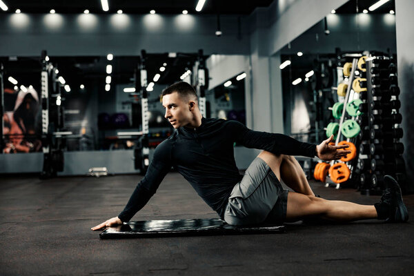 Young Sportsman Sits Mat Gym Does Stretching Exercises Stock Image