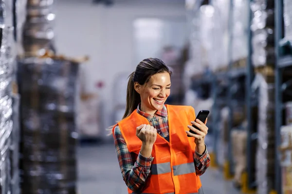 Storage Worker Looking Mobile Phone Celebrating Success — Stock Photo, Image