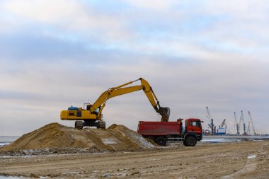 Sarı kazıcı şantiyede çalışıyor. Yol yapımı..