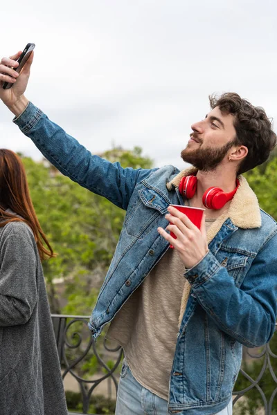 Handsome Caucasian Man Taking Self Portrait Outdoor Headphones Neck Young — Zdjęcie stockowe