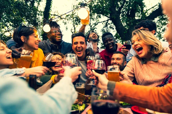 Group of people toasting with wine and beer - Happy friends having fun outdoor  hand toasting wine and beer glass -  group friends toasting for celebration  men and women toasting with wine  joy and friendship concept with young people on vacation