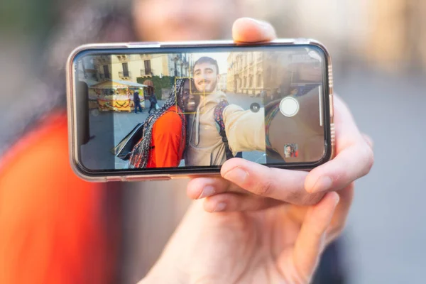 Happy multiethnic couple in the city taking photo - Smiling man and african girl taking selfie with smartphone on street  multiracial Happy couple having fun and taking a selfie  mixed race smiling