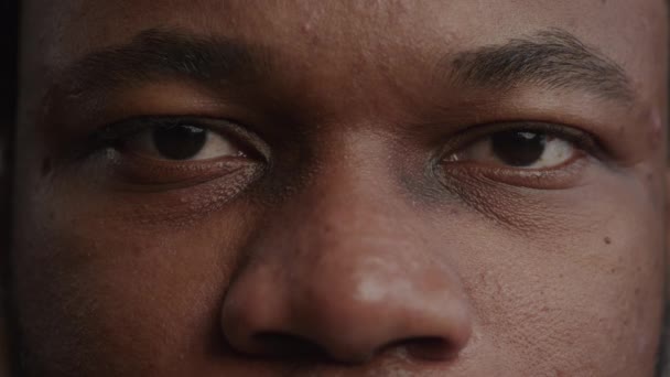 Extreme close-up of a black mans eyes opening in slow motion — Stock Video