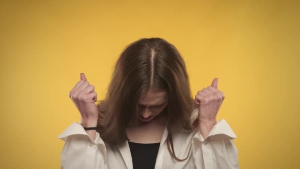 Молодая взрослая белая женщина беспокоится и делает глубокий вдох на ярко-желтом фоне — стоковое видео