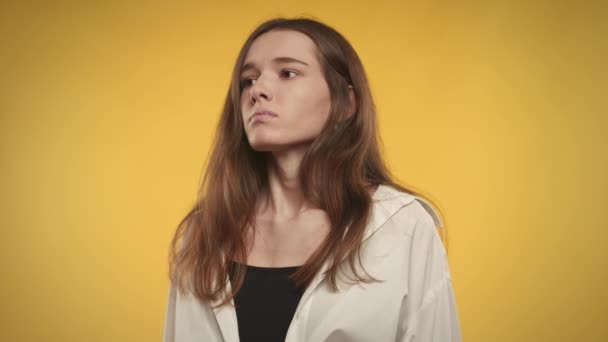 Junge erwachsene kaukasische Frau ist ängstlich und atmet tief durch auf einem leuchtend gelben Hintergrund — Stockvideo