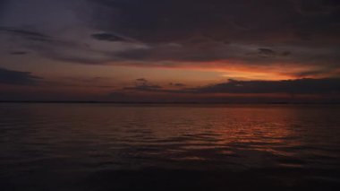 Calm waters and bright skies on a summer dawn on the river