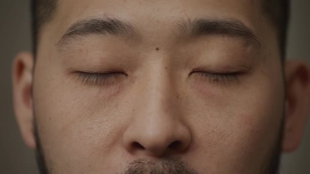 Day dreaming or closed asian mans eyes with a smile winckles close up — Stock video