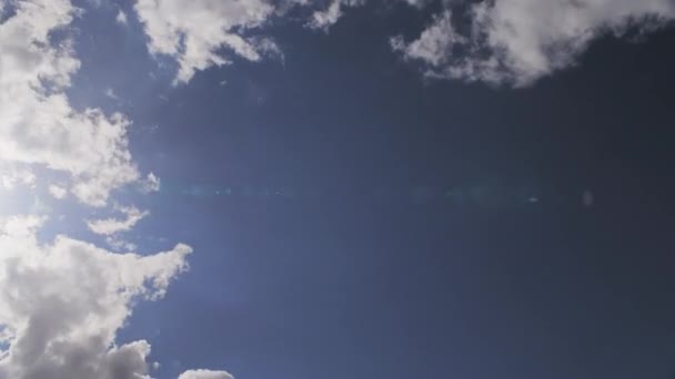 Timelapse Cumulus Clouds Passing Sunflare Hitting Lens — Stockvideo