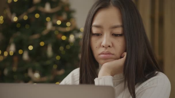 Young Adult Asian Woman Bored Front Laptop Computer Christmass Tree — Stockvideo