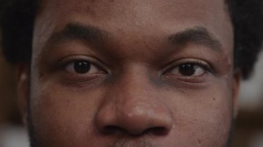 Surprised african american man eyes with his eyebrows up and blinking in slow motion