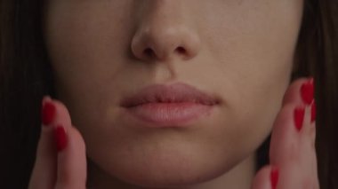 Close up of a mouth and woman hands in a wow or shock emotion expression gesture in slow motion